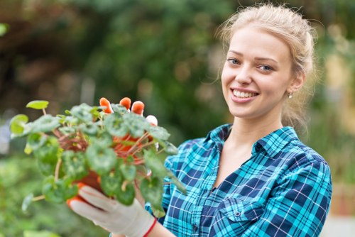 Gardener inspecting a garden with safety gear and paperwork